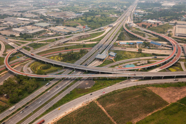 istock Aerial view of highway junctions with roundabout. Bridge roads shape circle in structure of architecture and transportation concept. Top view. Urban city, Bangkok at sunset, Thailand 1392451174