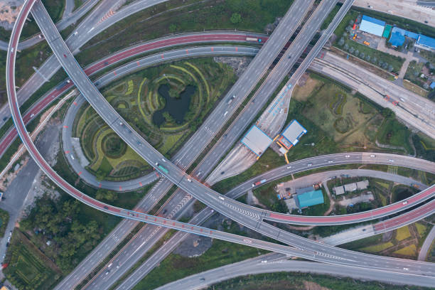 istock Aerial view of highway junctions with roundabout. Bridge roads shape circle in structure of architecture and transportation concept. Top view. Urban city, Bangkok at sunset, Thailand 1392451282