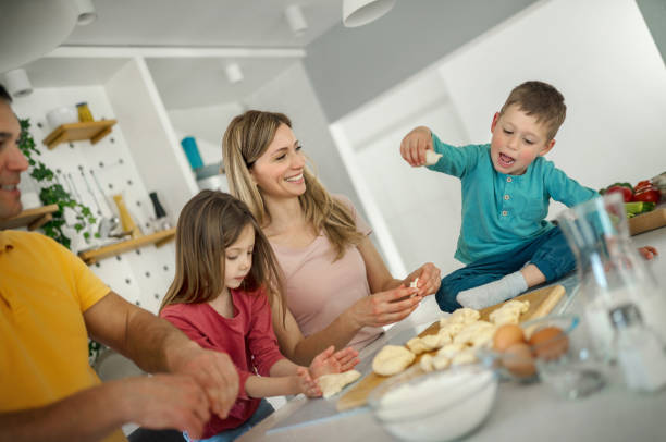 Young family making Easter cookies.