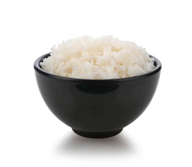 Photo of rice in black bowl on white background