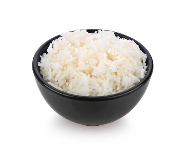 istock Rice in black bowl on white background 1392453695