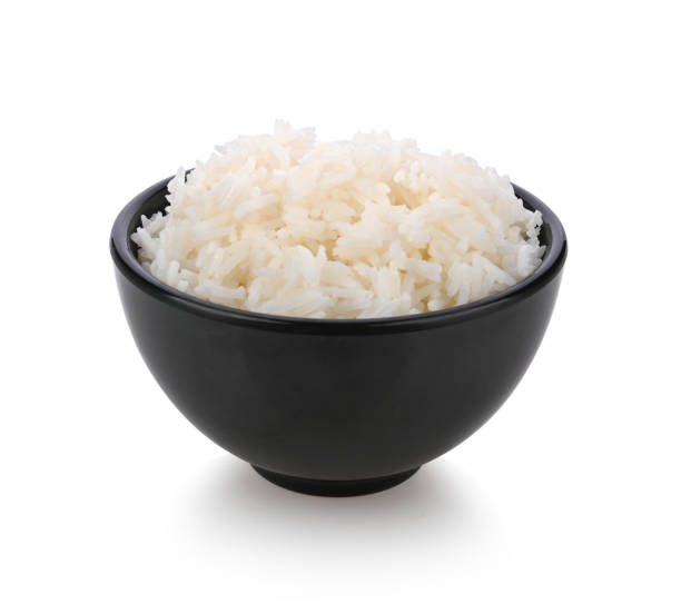 istock Rice in black bowl isolated on white background 1392454639