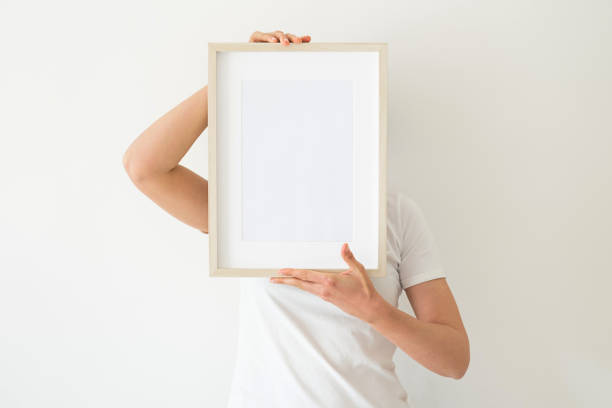 istock A wooden frame with empty space in women's hands 1392454925