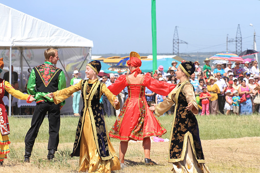 Small Chapurniki , Volgograd, Russia - May 24: Men and women in national costumes dance traditional folk dances in celebration of the holiday Sabantuy. May 24, 2014 in Volgograd, Russia.