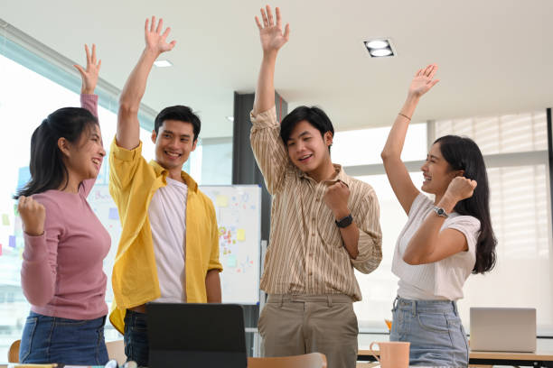 istock Happy office workers, Successful business startup team achieve goal 1392459248