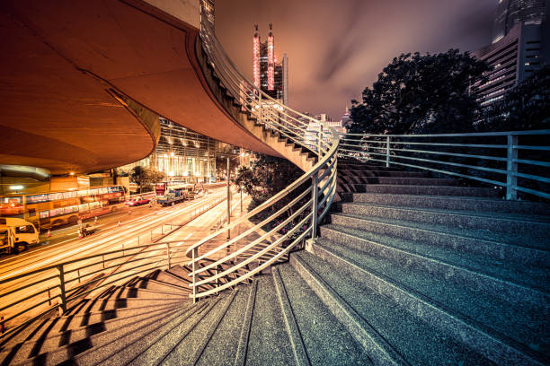 istock Spiral stairs with modern skyscrapers background at night 1392461152