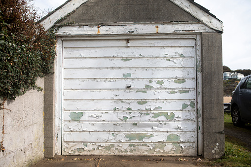 White paint peeling off garage doors