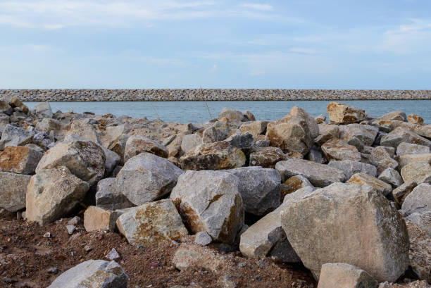 Large stones Was prepared in place of the sandy beach for the wave walls stock photo