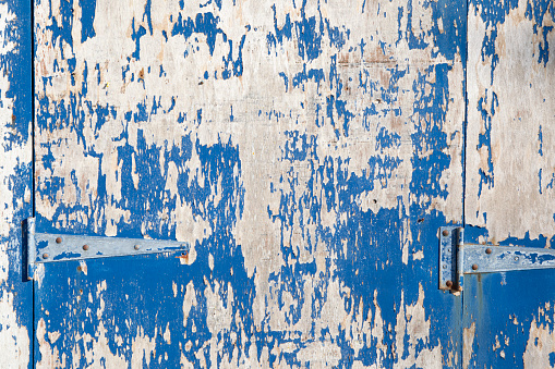 Rough, textured background of a painted wooden door