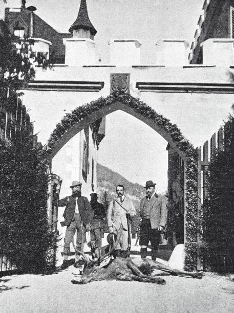 istock Men with a dead stag at the gate of a hunting lodge 1392470318