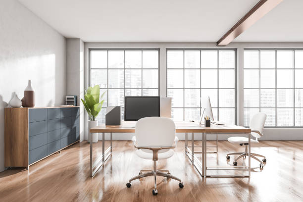istock Workplace interior with desk, computer, dresser and window with city view 1392472255