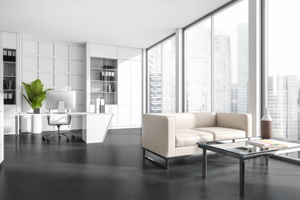 istock Corner view on office room interior with desktop, shelves, sofa 1392473308