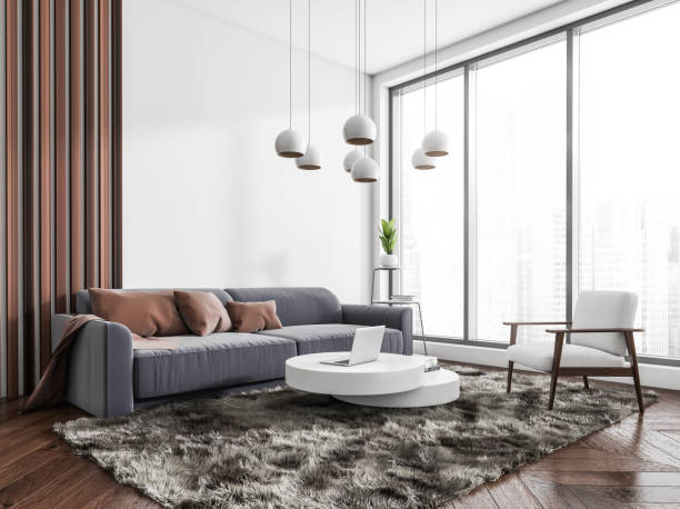 istock Chill zone interior with sofa and armchair, coffee table and panoramic window 1392473402
