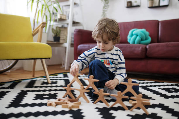 istock Cute little boy playing with wooden toy 1392473405