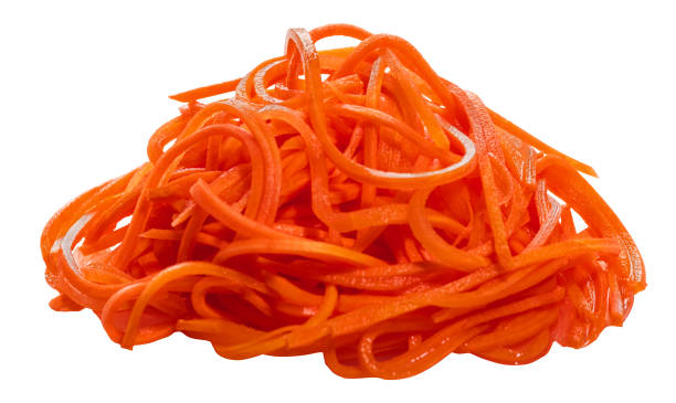 istock Heap of grated marinated carrots isolated on white background 1392473581
