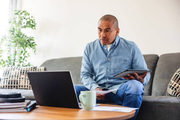 istock Mature Creative Professional Using Laptop In The Living Room To Work From Home 1392474382
