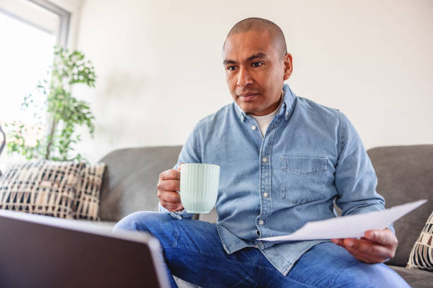 istock Mature Creative Professional Using Laptop In The Living Room To Work From Home 1392474464