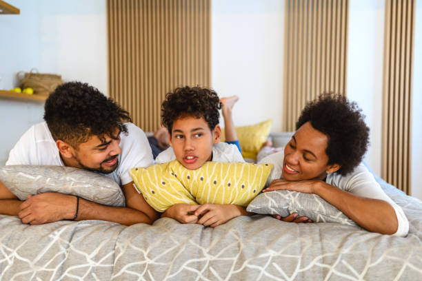 istock Happy family relaxing together in bed 1392474706
