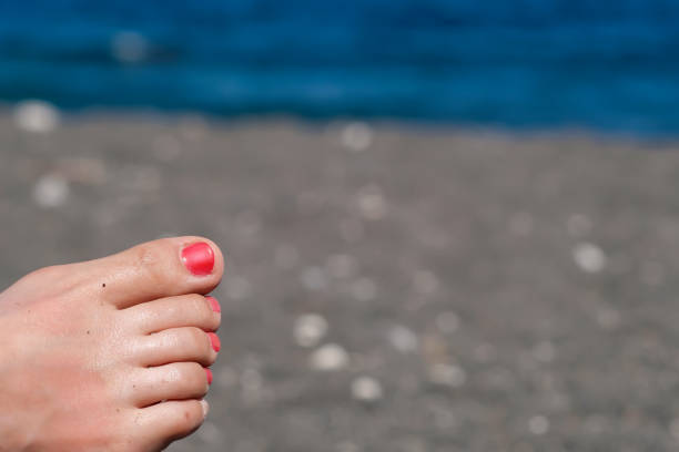 istock Female feet red nails 1392478076