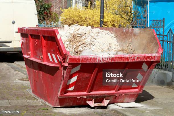 Red Settling Trough For Construction Rubble Standing On The Road Germany Europe Stock Photo - Download Image Now