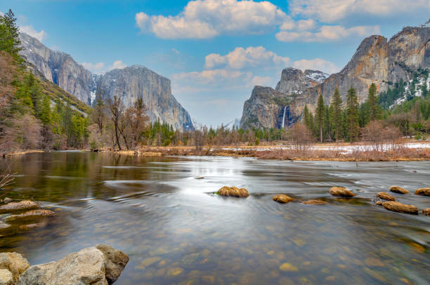 istock beautiful view in Yosemite valley with half dome and el capitan from Merced river 1392483415