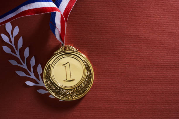 istock gold medal against red background 1392484644