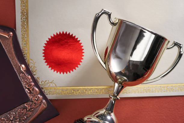 blank certificate and gold trophy with ribbon