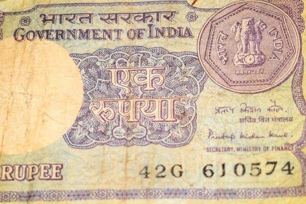 istock Old One Rupee notes combined on the table, India money on the rotating table. Old Indian Currency notes on a rotating table, Indian Currency on the table 1392484719