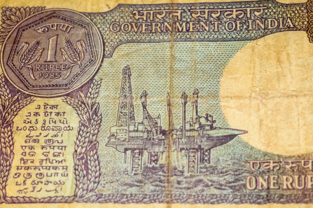 istock Old One Rupee notes combined on the table, India money on the rotating table. Old Indian Currency notes on a rotating table, Indian Currency on the table 1392484720
