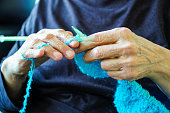 istock Old woman knitting. Needlecraft concept idea 1392485166