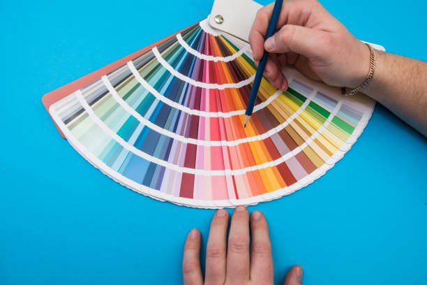 istock male hand choosing paint tone at color sampler isolated 1392485976