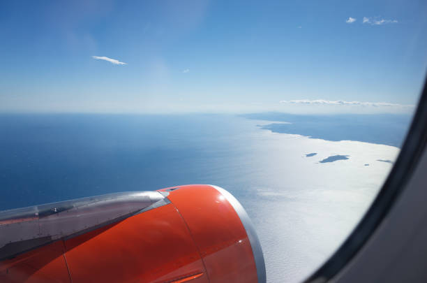 View from passenger jet - flying over the Mediterranean coast on beautiful sunny day, looking at Cannes and Cap d'Antibes on the cote d'Azur.