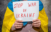 man hold poster with text stop no war in Ukraine