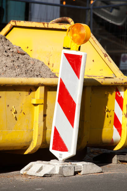 Container, yellow settling trough for construction rubble standing on the road Germany, Europe Container, yellow skip for construction rubble standing on the road Germany, Europe erde stock pictures, royalty-free photos & images