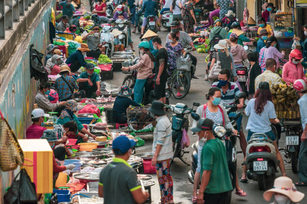 Busy local daily life of the morning street market in Ho Chi Minh city, Vietnam. People can seen exploring around the market. stock photo