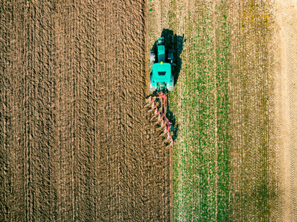 istock Tractor preparing the soil for planting crops seen from above 1392491920