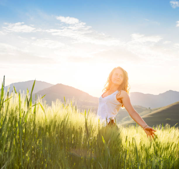 istock Young woman in wheat field 1392493142
