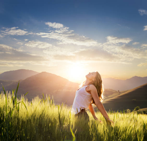istock Woman relaxing in wheat field at sunset 1392493162