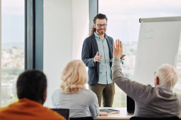 istock A young hipster educator holding a course for a multiracial group of elderly students in the classroom. 1392493328