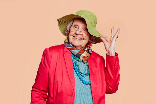 istock Cheerful stylish elderly grandmother posing at studio 1392498671