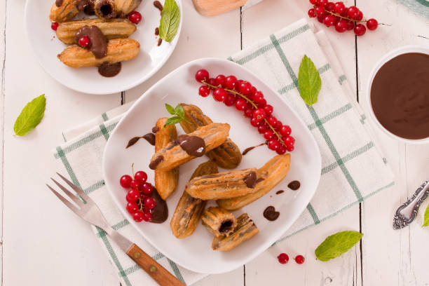 istock Mini churros with chocolate dipping sauce. 1392500703