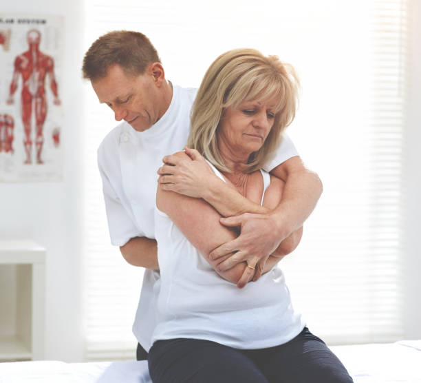 istock Shot of a chiropractor adjusting his clients spine and back 1392501049