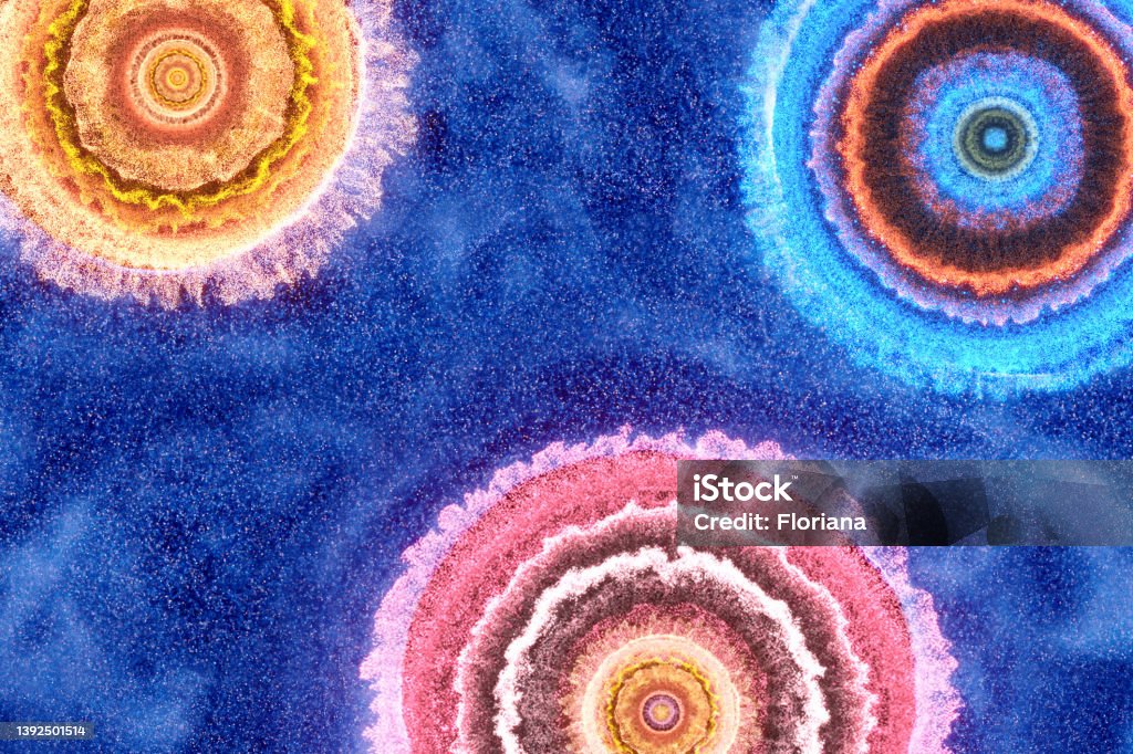 Celebration background Multicolored powder form circles, stars or fireworks on dark blue background, CGI. Backgrounds Stock Photo