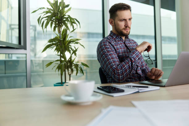 istock Serious businessman working on laptop in the office. 1392506067