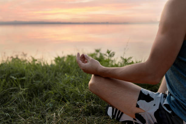 istock Man meditating near river, closeup. Space for text 1392510538
