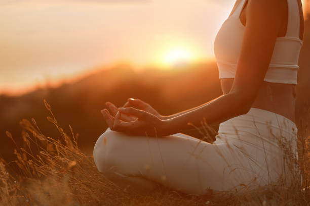 istock Woman meditating outdoors at sunset, closeup view 1392512480