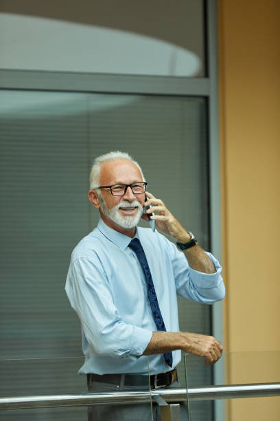 istock Portrait of a elderly businessman using mobile phone 1392517868