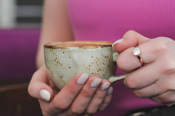 istock A cup of hot cappuccino in a woman's hands 1392518095