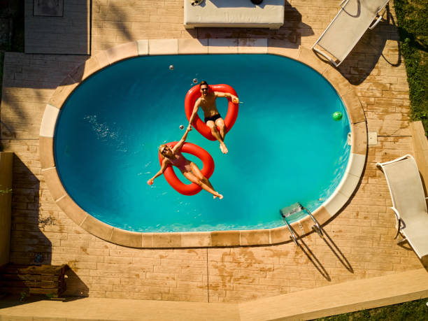 istock Couple relaxing in a swimming pool 1392521914