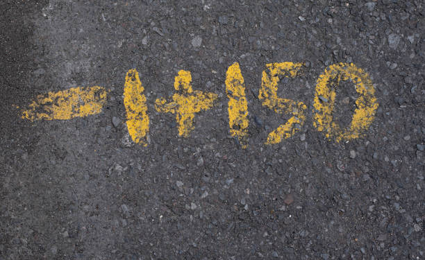 istock Yellow painted numbers on pavement texture 1392523560